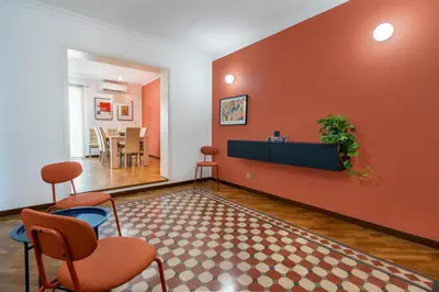 a living room with orange walls and chairs at Casa Bentivegna in Palermo