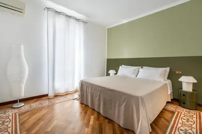 a bedroom with a bed and a large window at Casa Bentivegna in Palermo