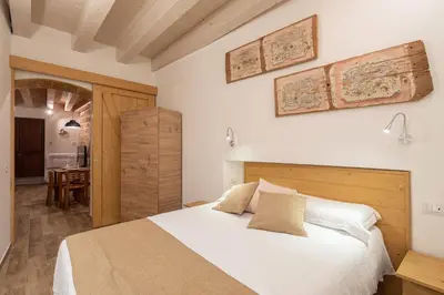 a bedroom with a white bed and a table at Loft Vetriera in Palermo