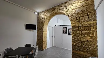 an archway in a room with a stone wall at Suites Masculu & Fimmina in Palermo