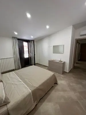 a bedroom with a large bed and a television at Gravina in Trappeto
