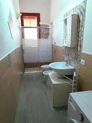 a bathroom with two toilets and a sink at little Italy in Castellammare del Golfo