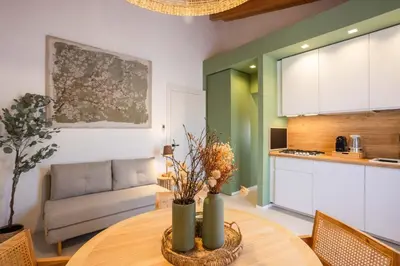a kitchen and living room with a table and a couch at Le Terrazze dei Candelai 