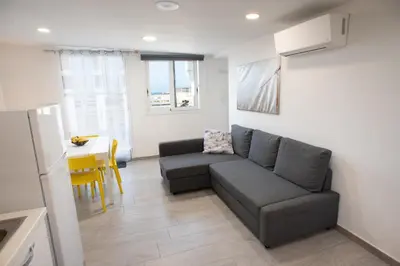a living room with a couch and a table at Appartamento con terrazza in Isola delle Femmine