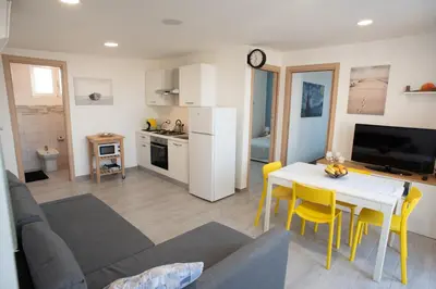 a living room with a couch and a table at Appartamento con terrazza in Isola delle Femmine