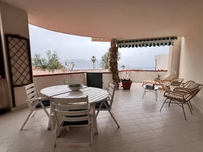 a table and chairs on a patio with a view at Isola delle Femmine Holiday Nancy in Isola delle Femmine