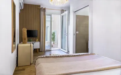 a bedroom with a bed and a television in a room at Curtigghiu Mondello in Mondello