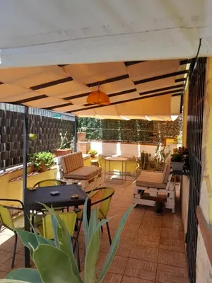 a patio with tables and chairs on a building at Sea Holiday Orchidea in Palermo