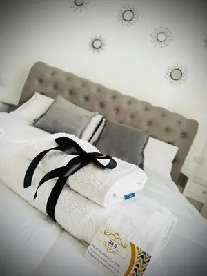 a pile of towels sitting on top of a bed at Affittacamere Palermo Pirri in Palermo