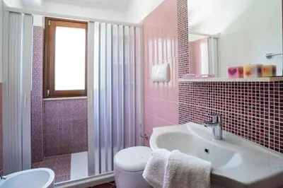 a bathroom with a sink and a toilet and a mirror at B&B Pietre Preziose in Castelluzzo