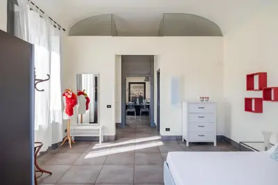 a bedroom with a bed and a dresser and a mirror at Palazzo Sant'Agostino in Palermo