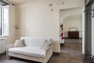 a living room with a white couch and a hallway at Palazzo Sant'Agostino in Palermo