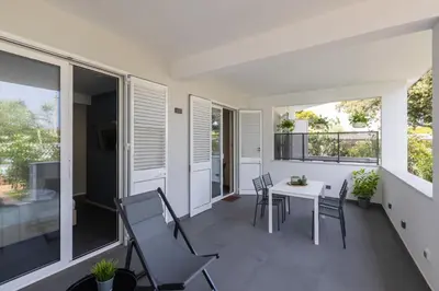 a balcony with a white table and chairs at Sweet Sicily Apartments in Carini