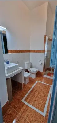 a bedroom with a blue wall and a bed with pillows at CASA CASCIOTTO in Palermo