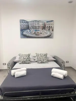 a bed with pillows on it in a room at La casetta di salvuccio in Palermo