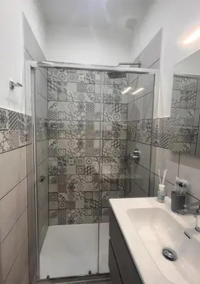 a bathroom with a shower and a sink at La casetta di salvuccio in Palermo