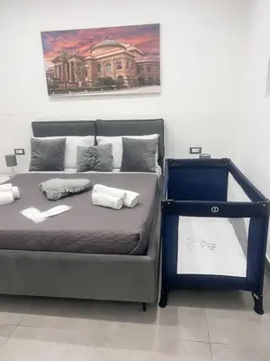 a bed with two towels on it in a room at La casetta di salvuccio in Palermo