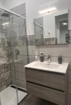 a bathroom with a sink and a shower at La casetta di salvuccio in Palermo