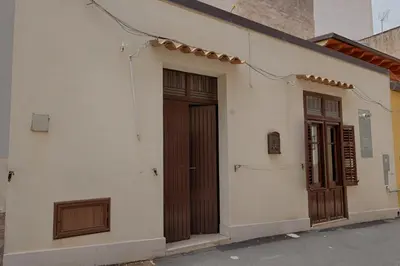 a building with two doors on the side of it at GuestHost - Il Piccolo Scrigno - Comfy & Central Studio x5 in Castellammare del Golfo