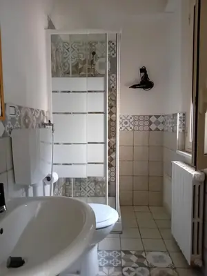a bathroom with a white tub and a toilet at BBX Palermo Centro in Palermo