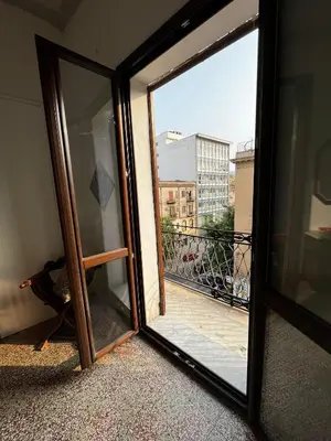 a sliding glass door with a view of a balcony at Mille Lire Peppe's Home in Palermo