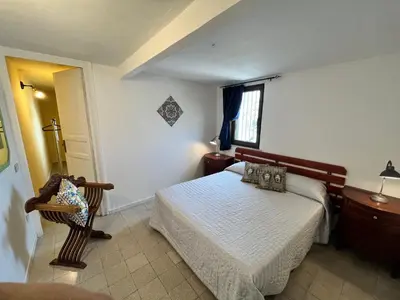 a bedroom with a bed and a chair and a window at Mille Lire Peppe's Home in Palermo