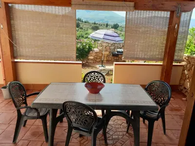 a table and chairs on a patio with a view at Mediterraneo in Castellammare del Golfo