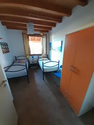 a living room with two beds and a window at Mediterraneo in Castellammare del Golfo