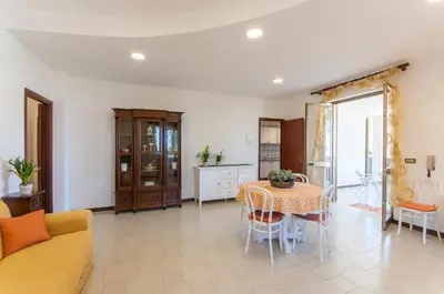 a living room with a table and a couch at Villa Saracena in Castellammare del Golfo