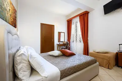 a bedroom with a bed and a window at Hotel La Darsena in San Vito lo Capo
