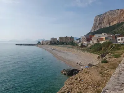 a view of a beach with buildings and the ocean at GIORGISA in Palermo