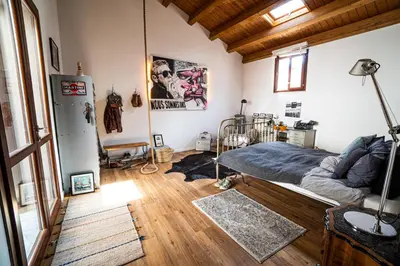 a bedroom with a bed in the corner of a room at Solemar Sicilia - Palazzo Vetrano Centro Storico in Palermo