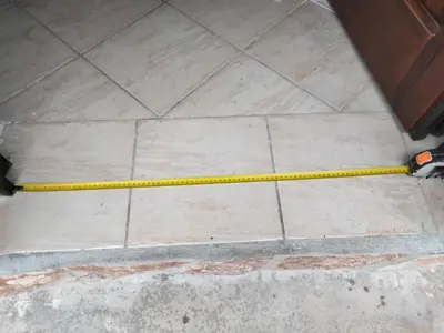 a yellow hose on a tile floor next to a door at Phoenix Apartment in Terrasini