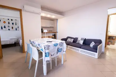 a living room with a table and a couch at Apartment on the Beach - Large Terrace in Alcamo