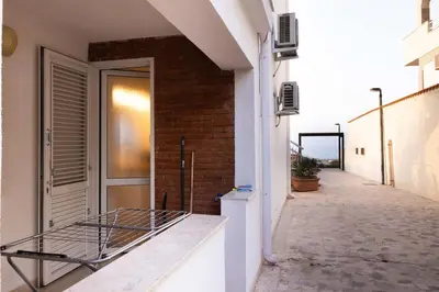 a bed on the side of a building at Apartment on the Beach - Large Terrace in Alcamo