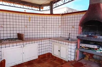 a kitchen with a stove top oven in a room at Villa Rosetta vacanze al mare in Carini