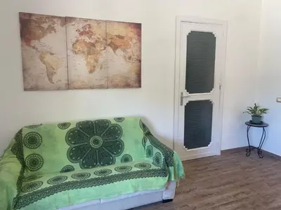 a room with a couch and a map on the wall at Villa Eufrosine in Palermo