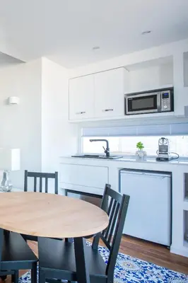 a kitchen with a wooden table and a kitchen with white cabinets at Vista sulle Cupole by Wonderful Italy in Palermo