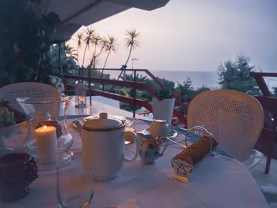 a table with a candle on a table with chairs at Sea apartment & pool 2 in Palermo