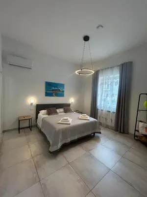 a bedroom with a large bed with two towels on it at Clio's House - Mondello in Mondello