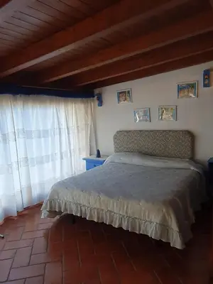 a bedroom with a bed and a window at La Casetta del Melograno in Mondello