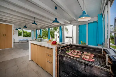 a kitchen with a grill with meat on it at Villa Sikelia in Alcamo