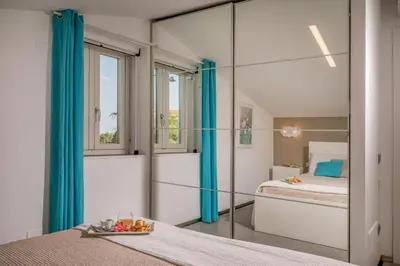 a bedroom with a mirror and a bed at Villa Sikelia in Alcamo