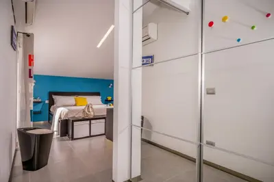 a bedroom with a bed with a blue accent wall at Villa Sikelia in Alcamo