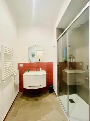 a bathroom with a white sink and a mirror at Da Olga in Palermo