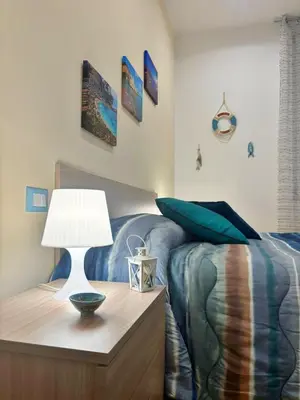a bedroom with a bed and a table with a lamp at D'Aragona Guest House in Palermo