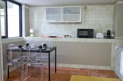a kitchen with a table with chairs and a microwave at Sea apartment 1 in Palermo