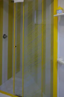 a shower with a glass door in a bathroom at Sea apartment 1 in Palermo