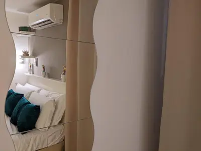 a shelf with towels and a mirror in a room at Iverlid Ballarò in Palermo