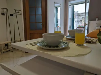 a table with a bowl and two glasses of orange juice at Iverlid Ballarò in Palermo